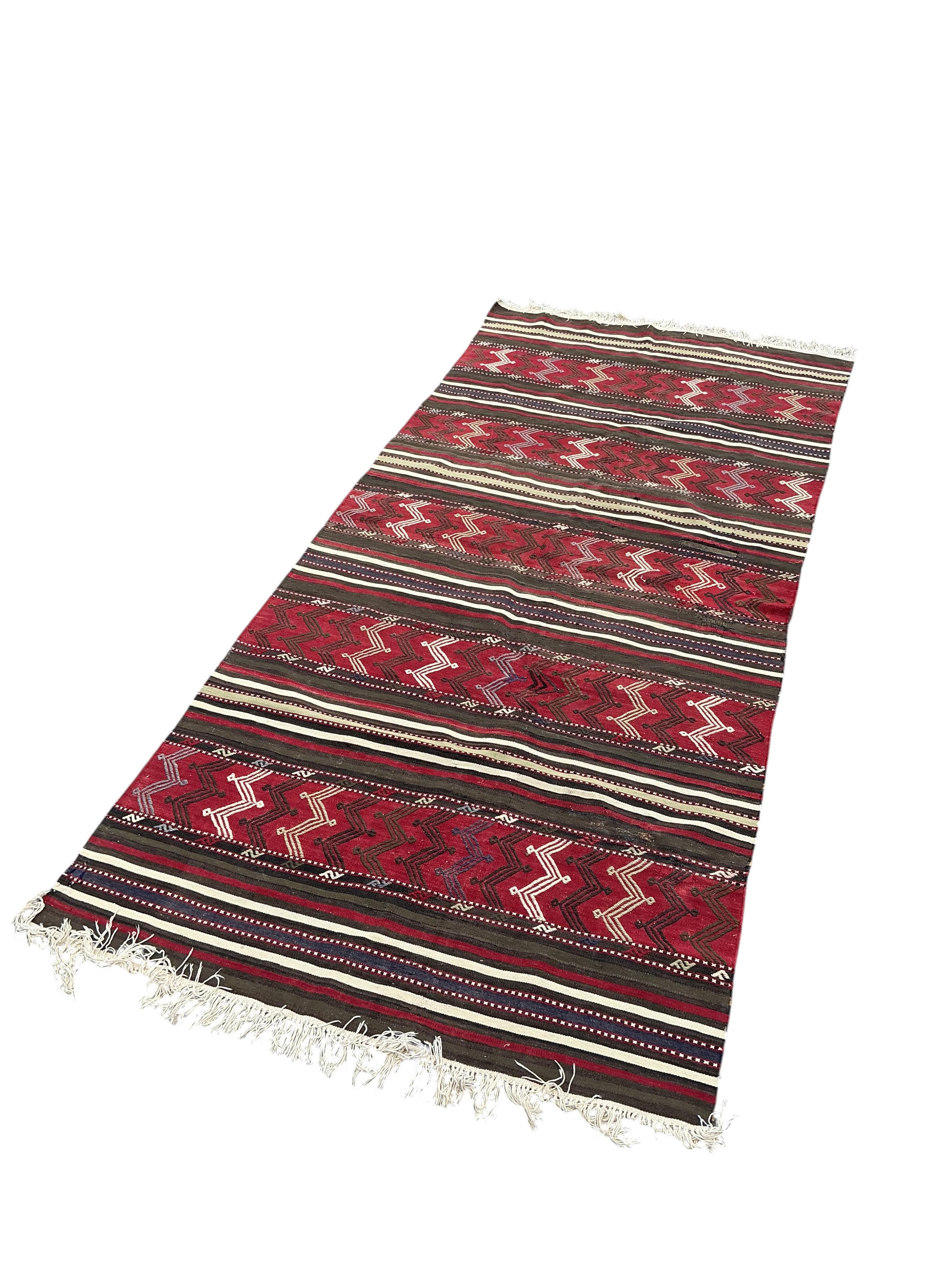 A Turkish kilim flat weave hall carpet, 320 x 140cm